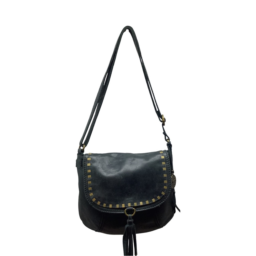 The Sak Serrano black leather saddle bag with gold accents and a front tassel